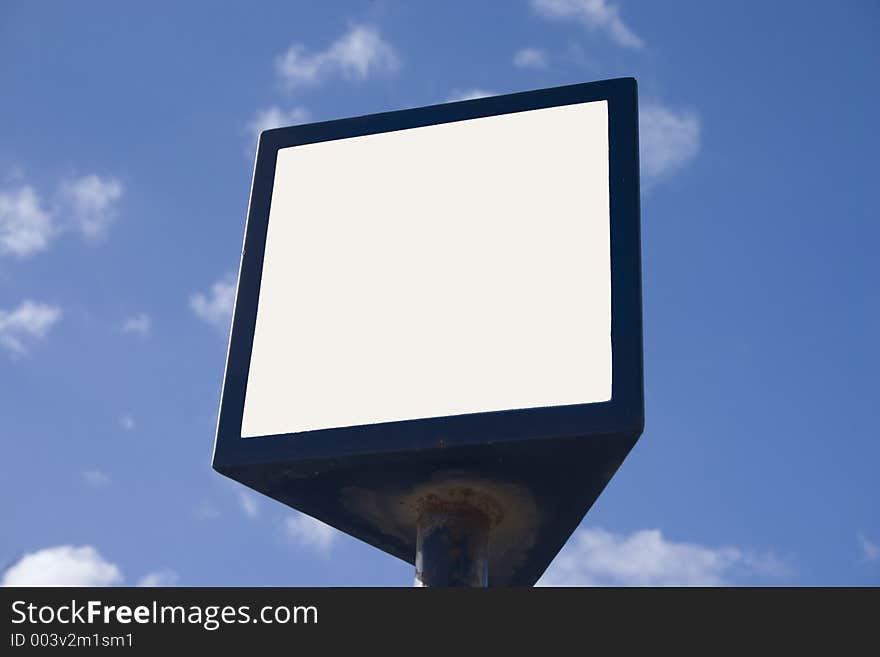 Photo of a blank billboard on a blue sky background.