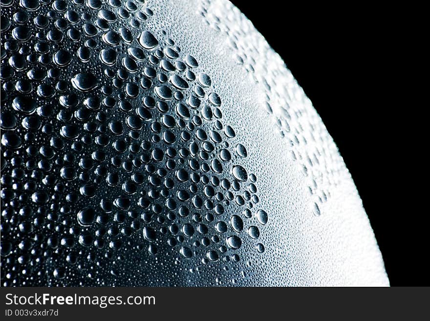 A creative shot taken of a water bottle with condensation on the inside featuring its smooth surface. A creative shot taken of a water bottle with condensation on the inside featuring its smooth surface