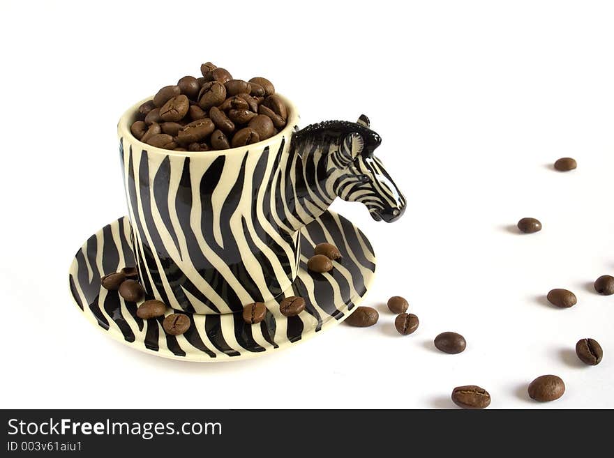 Cup of coffee simulating a zebra with coffee grains in white background