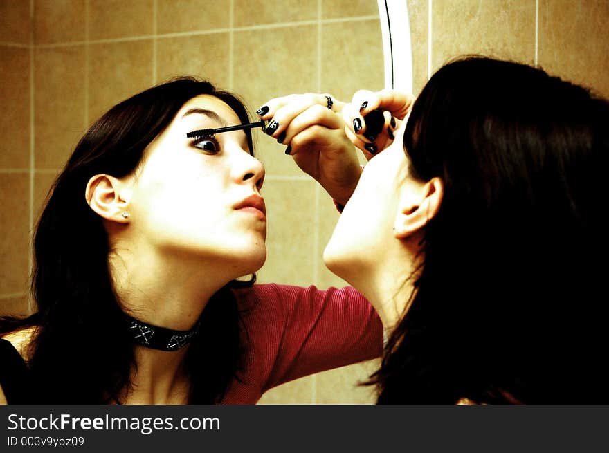 A girl applying mascara. A girl applying mascara