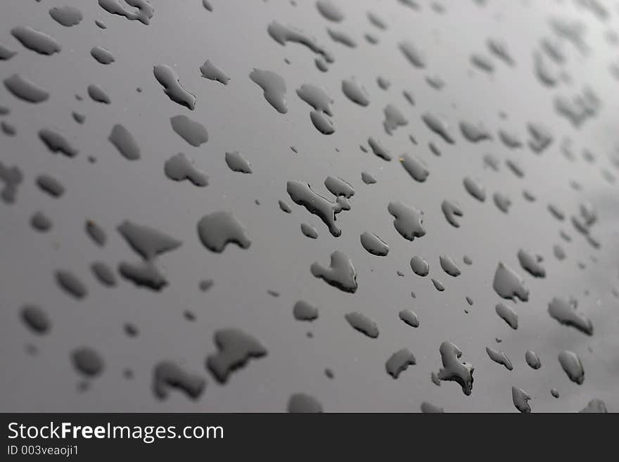 Water droplets on black paint. Water droplets on black paint.