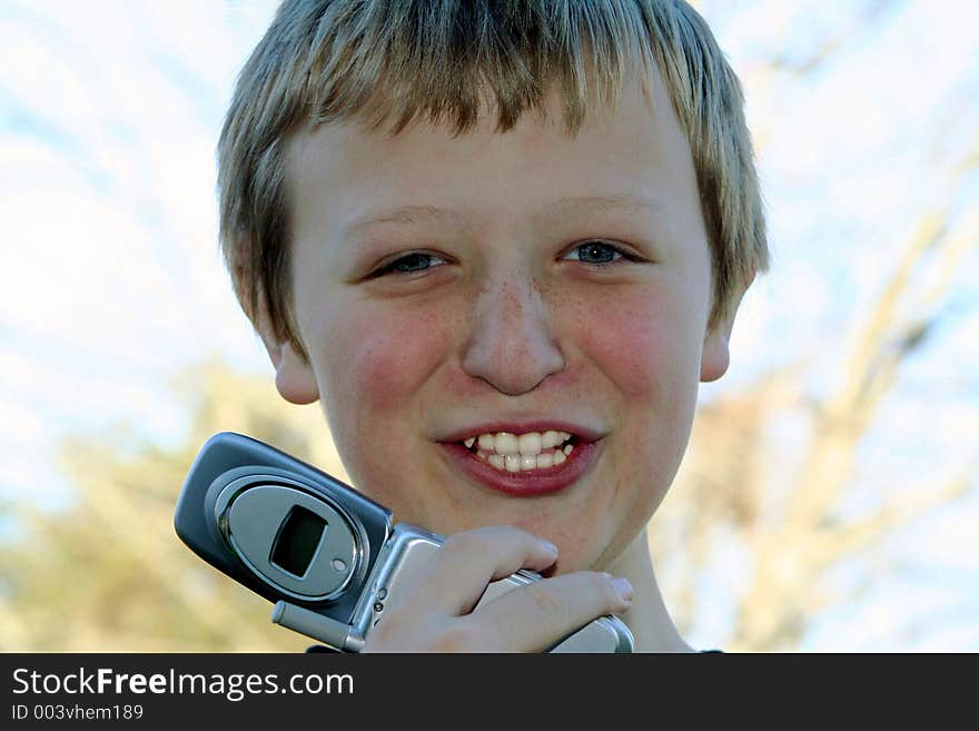 Preteen boy talking on a cell phone. Preteen boy talking on a cell phone.