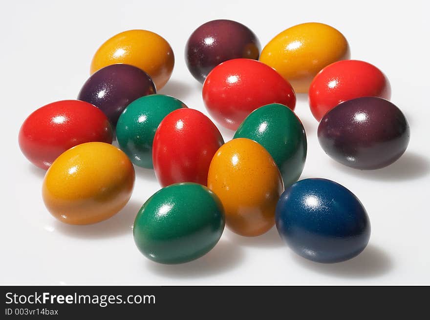 Many coloured eggs on white background. Many coloured eggs on white background