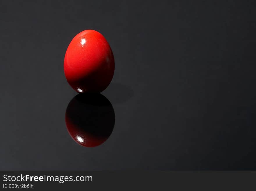 Red egg on black background. Red egg on black background