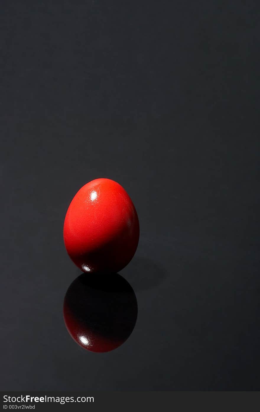 Red egg on black background. Red egg on black background