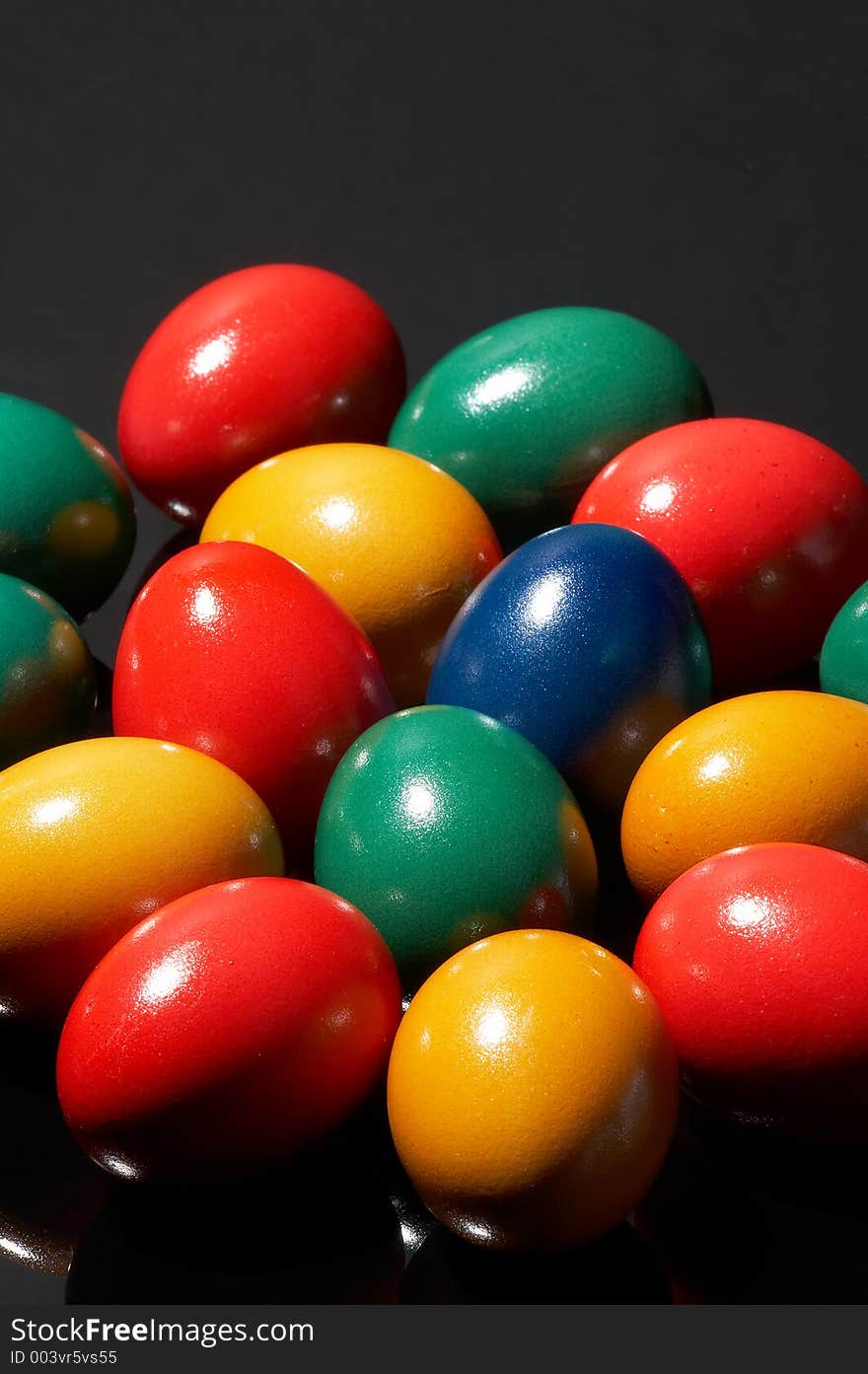 Many coloured eggs on black background. Many coloured eggs on black background