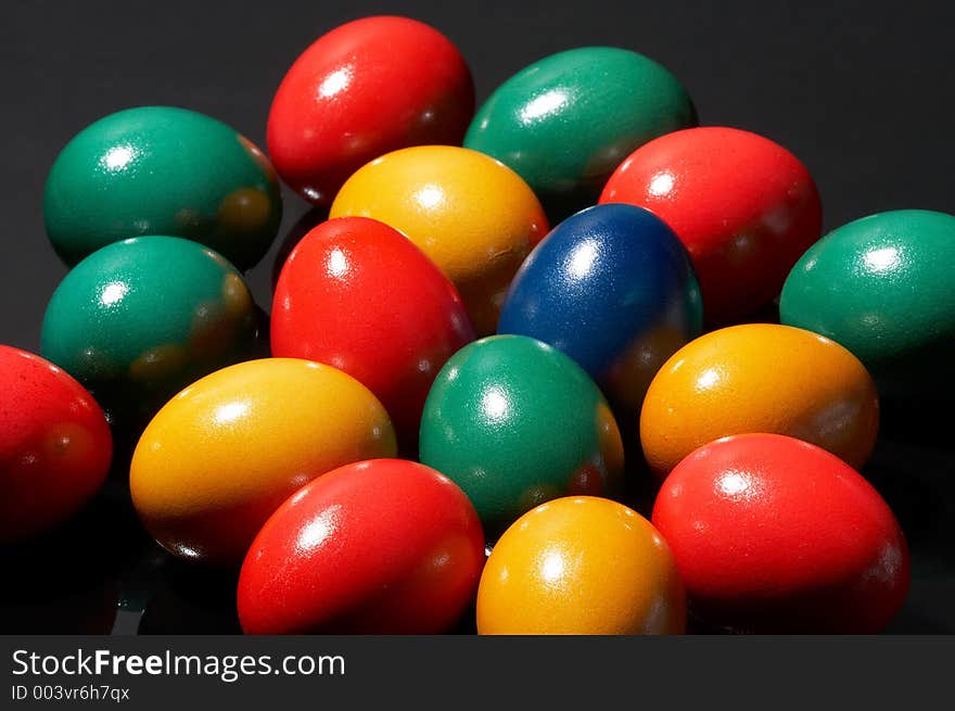 Many coloured eggs on black background. Many coloured eggs on black background