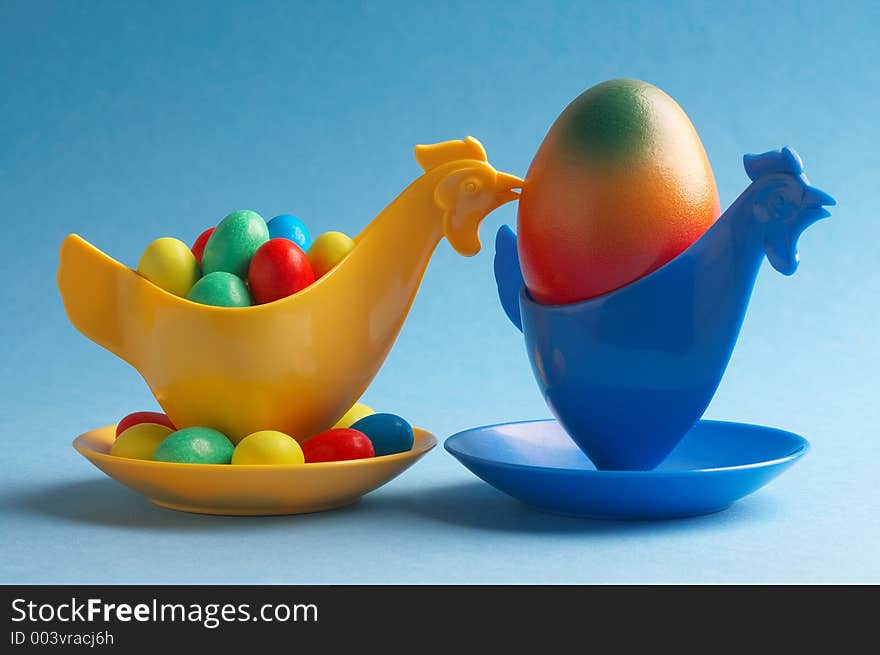 Yellow eggcup behind blue eggcup. Yellow eggcup behind blue eggcup