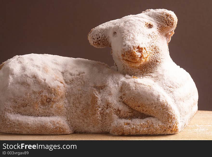 Easter lamb laying on brown background