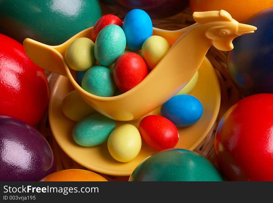 Choco eggs in a eggcup on coloured eggs. Choco eggs in a eggcup on coloured eggs