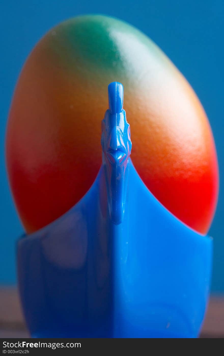 Blue eggcup chicken formed with a coloured egg in it. Blue eggcup chicken formed with a coloured egg in it