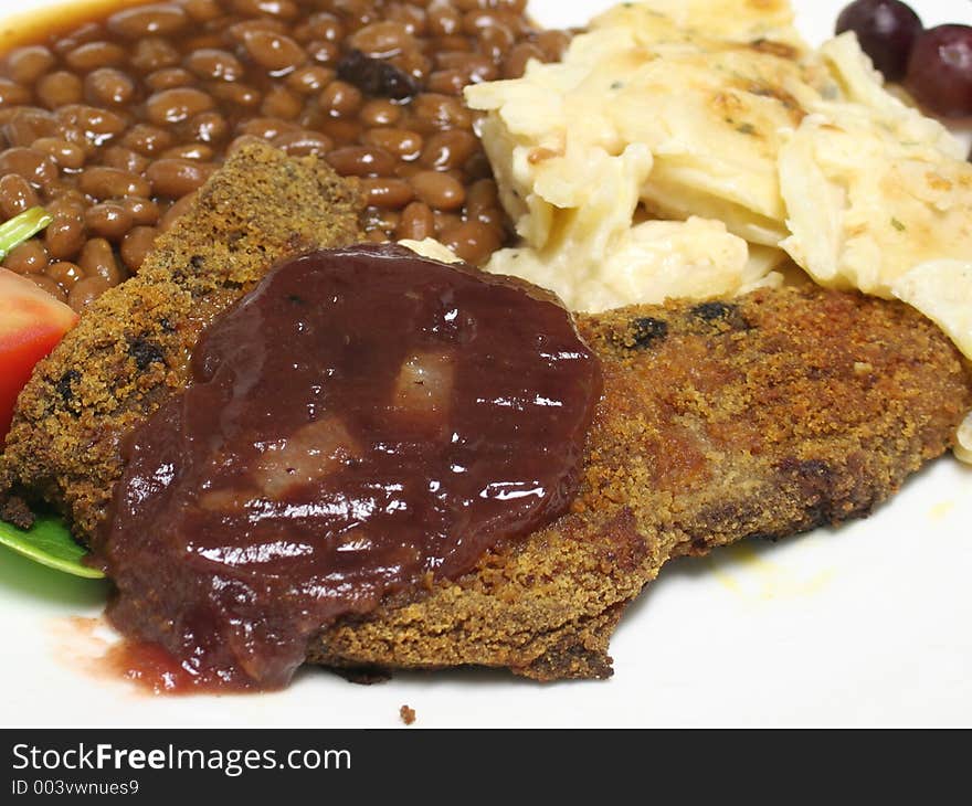 Close up of onion cranberry glaze on a fried pork chop. Close up of onion cranberry glaze on a fried pork chop.