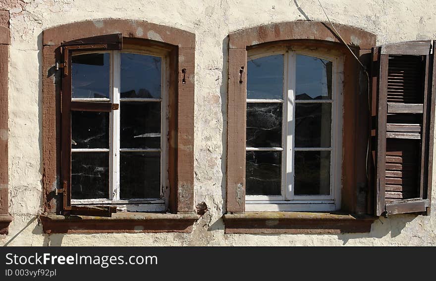 Spider webs can be seen on the windows of that derelict mill in the Palatinate area of Germany. Spider webs can be seen on the windows of that derelict mill in the Palatinate area of Germany