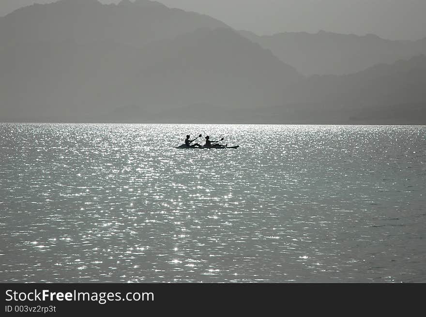 Canoe boat on the sunny surface of the sea. Canoe boat on the sunny surface of the sea