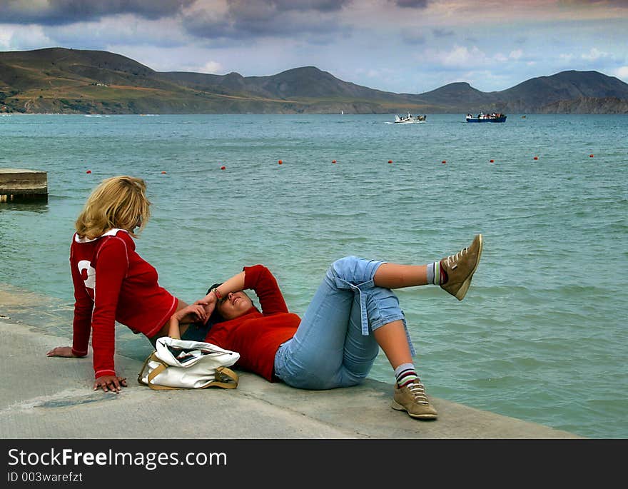 Girlfriends on edge of a pier. Girlfriends on edge of a pier