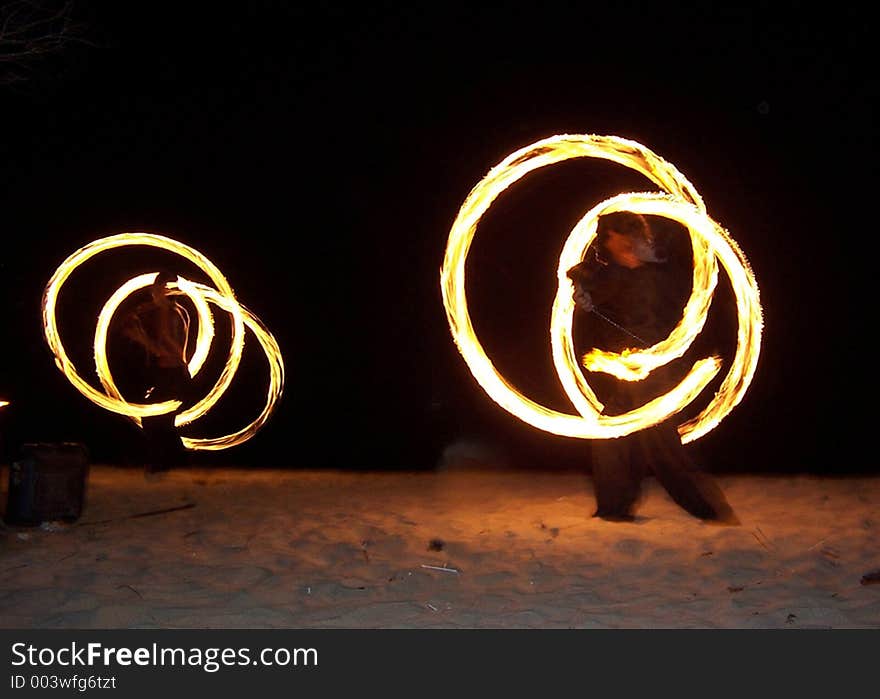 Fire jugling on the beach at night. Fire jugling on the beach at night