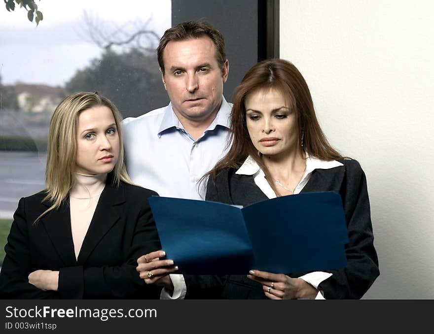 Members of a business team with strong, confident expressions on their faces - front view. Members of a business team with strong, confident expressions on their faces - front view