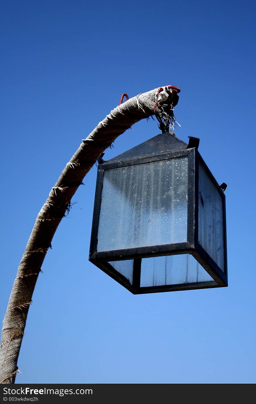 Old lamp on blue sky