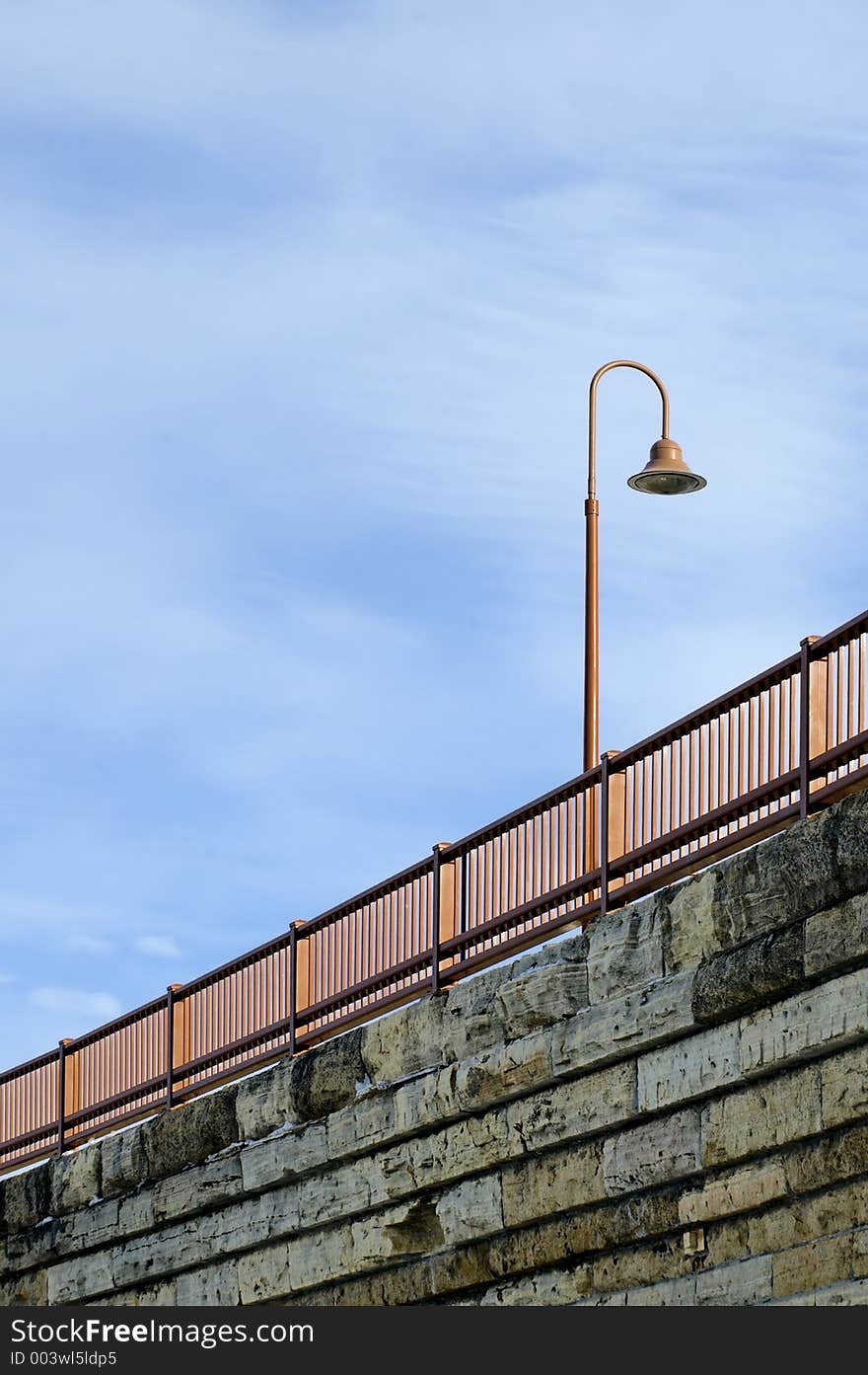 Lamp of Stone Arch Bridge in Minneapolis, MN against blue sky. Lamp of Stone Arch Bridge in Minneapolis, MN against blue sky