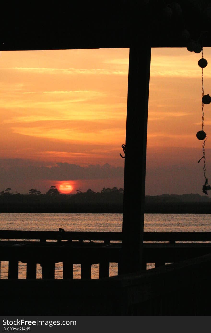 Sunset on river through dock