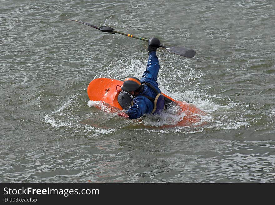 Lone kayaker practicing recovery from roll over. Lone kayaker practicing recovery from roll over