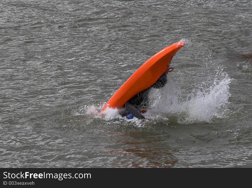 Lone kayaker practicing recovery from roll over. Lone kayaker practicing recovery from roll over