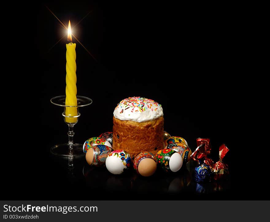 Easter eggs cake candies and candle still-life. Easter eggs cake candies and candle still-life