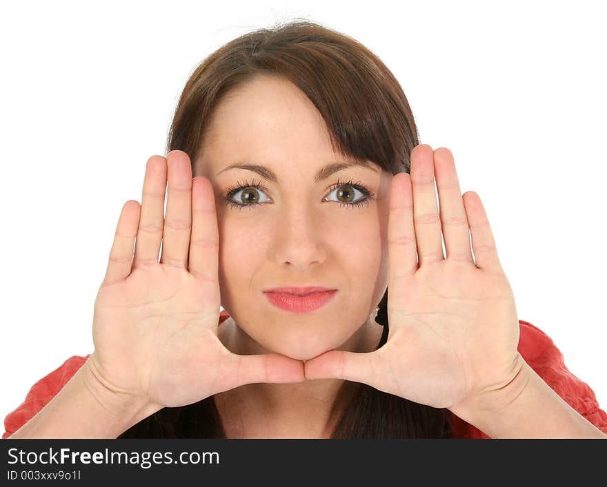 Beautiful young woman framing face with hands. Shot in studio over white.