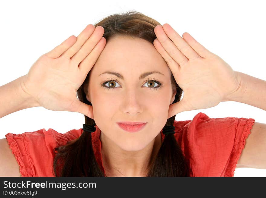 Beautiful young brunette woman framing face with hands.