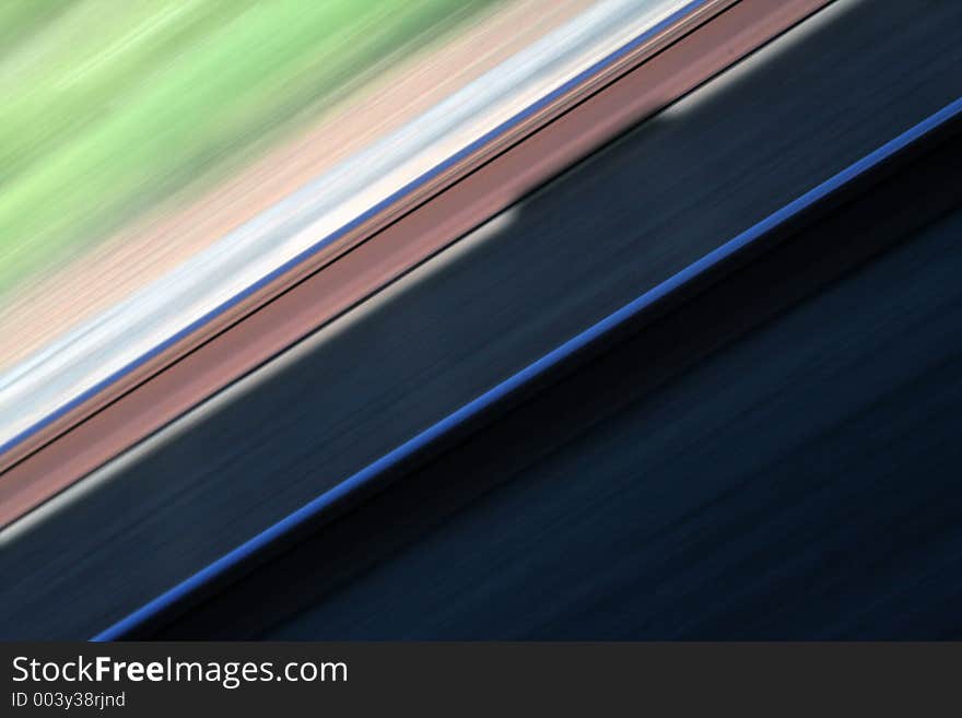 Railway moving fast past a moving train