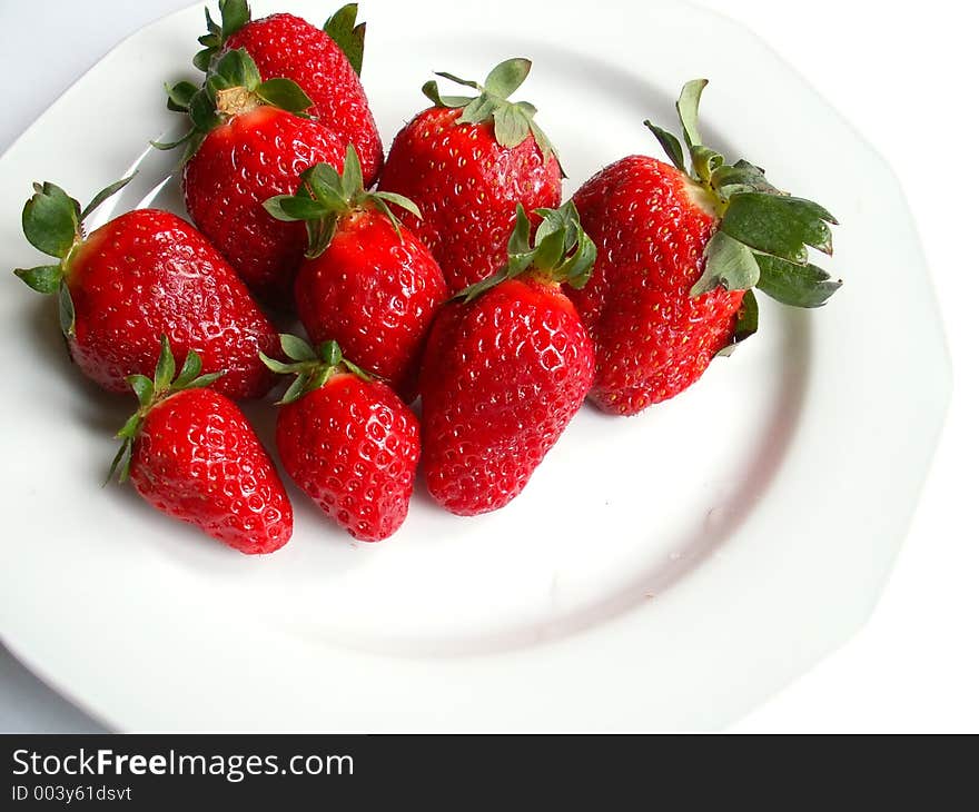 Strawberries over white