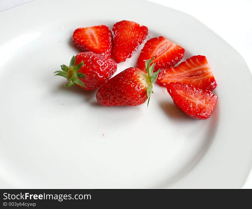 Strawberries over white