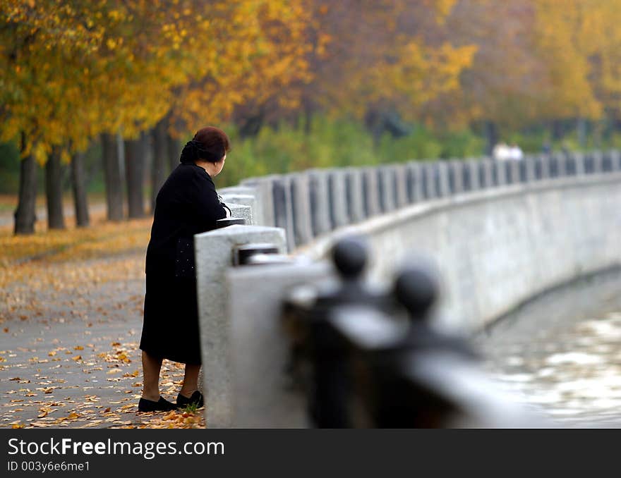 The woman stands on the bridge. The woman stands on the bridge