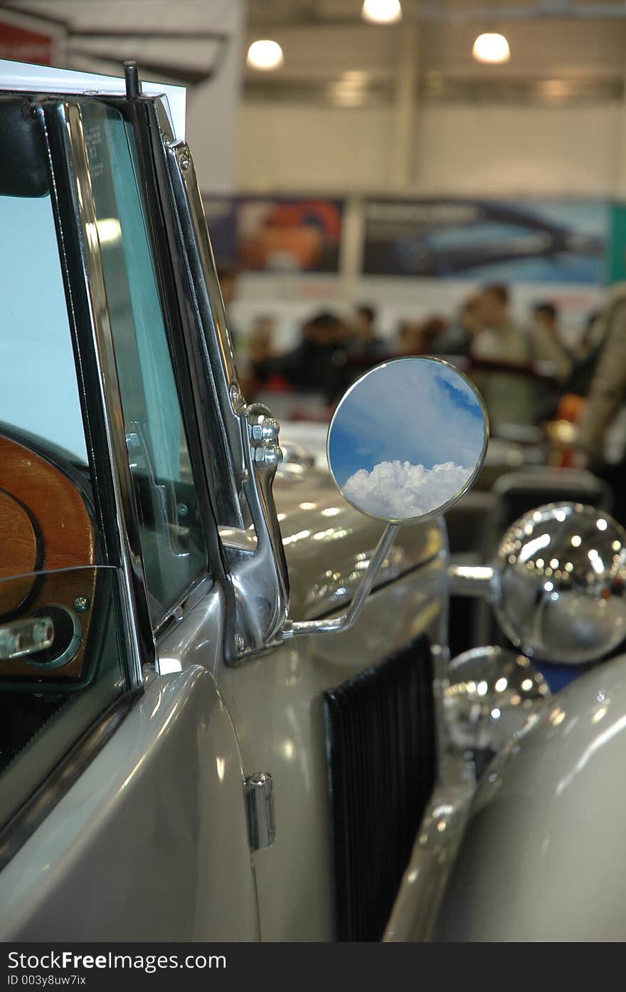 Rear view mirror from the old car with reflected skies. Rear view mirror from the old car with reflected skies