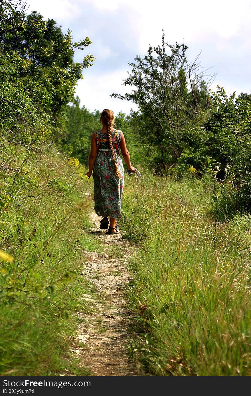 The girl going on a wild footpath. The girl going on a wild footpath