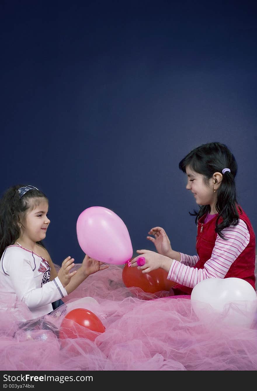 Young and beautiful girls playing with balloons