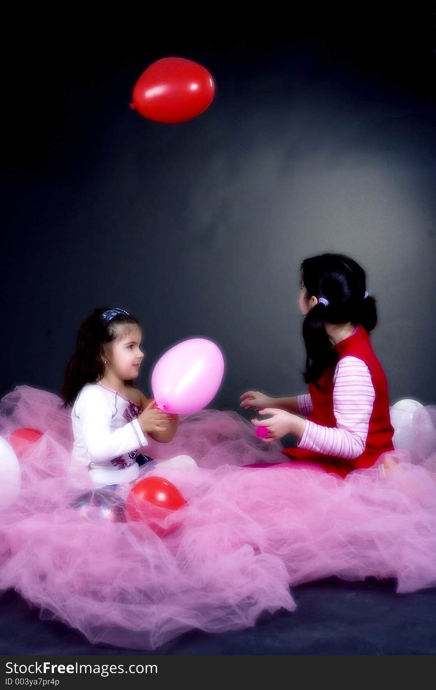 Young and beautiful girls playing with balloons