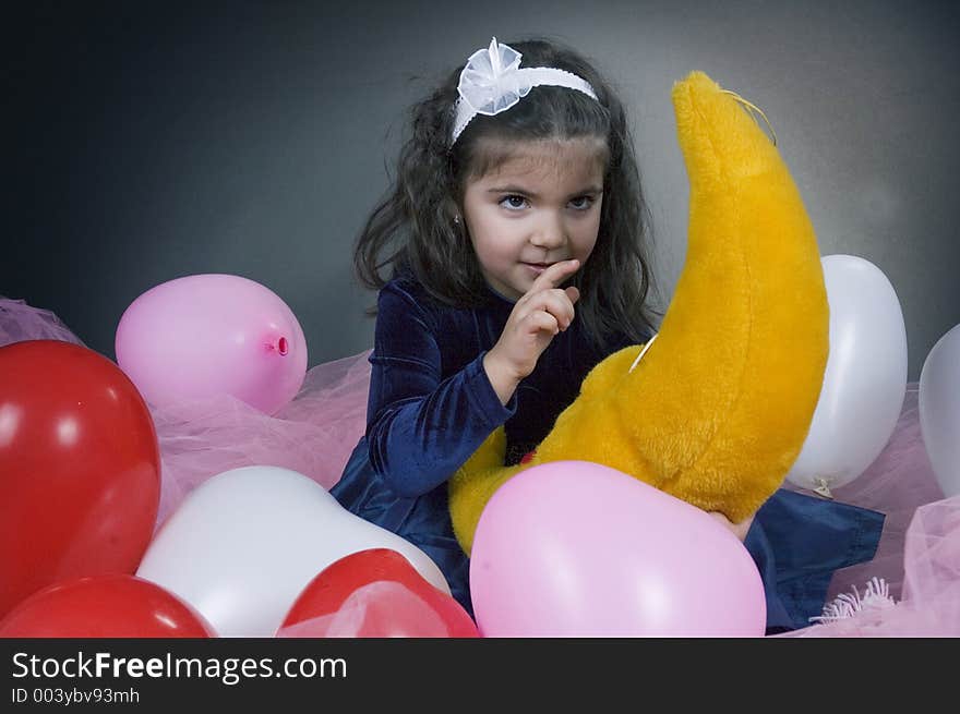 Sweet young girl playing with her plush moon