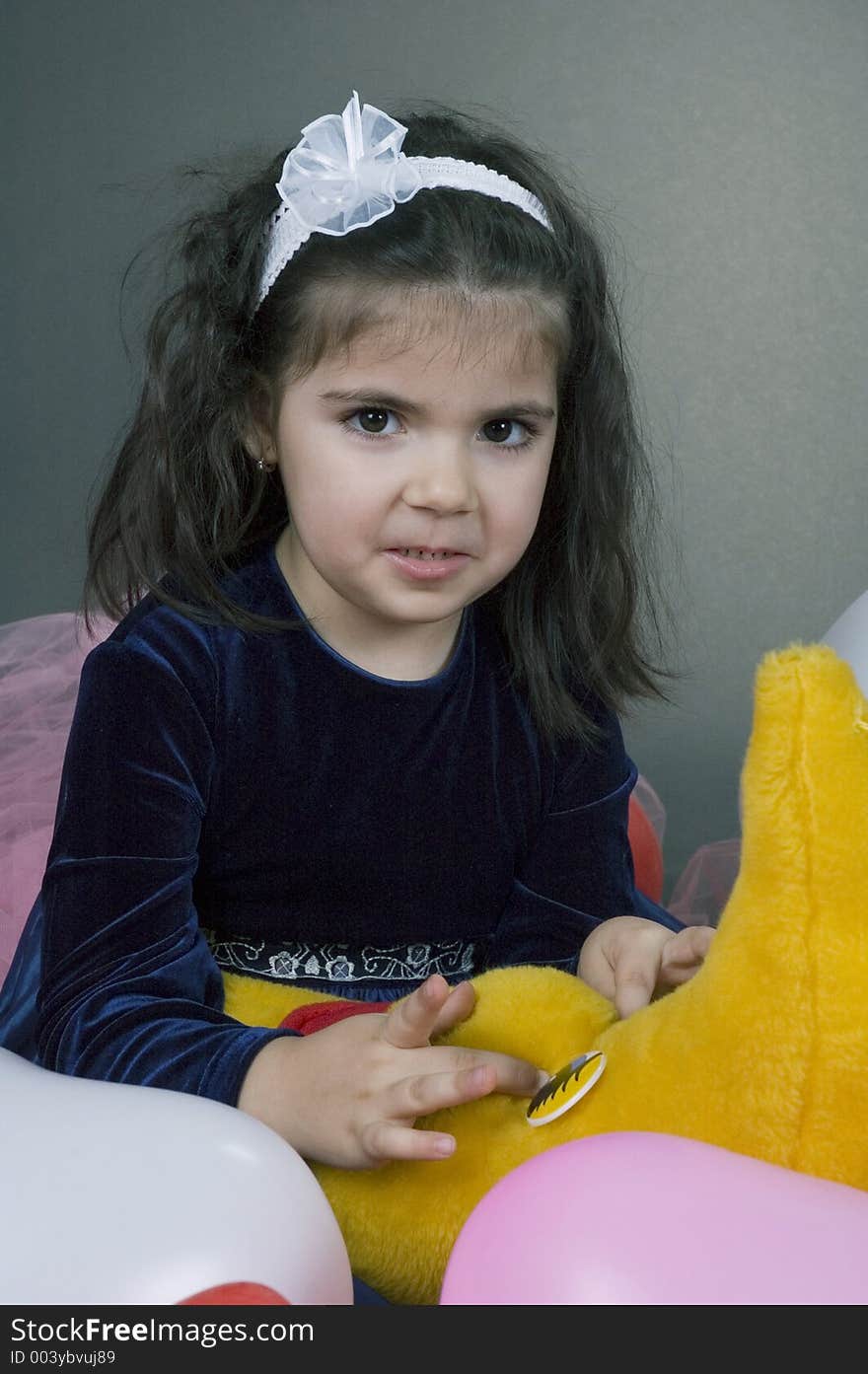 Sweet young girl playing with her plush moon