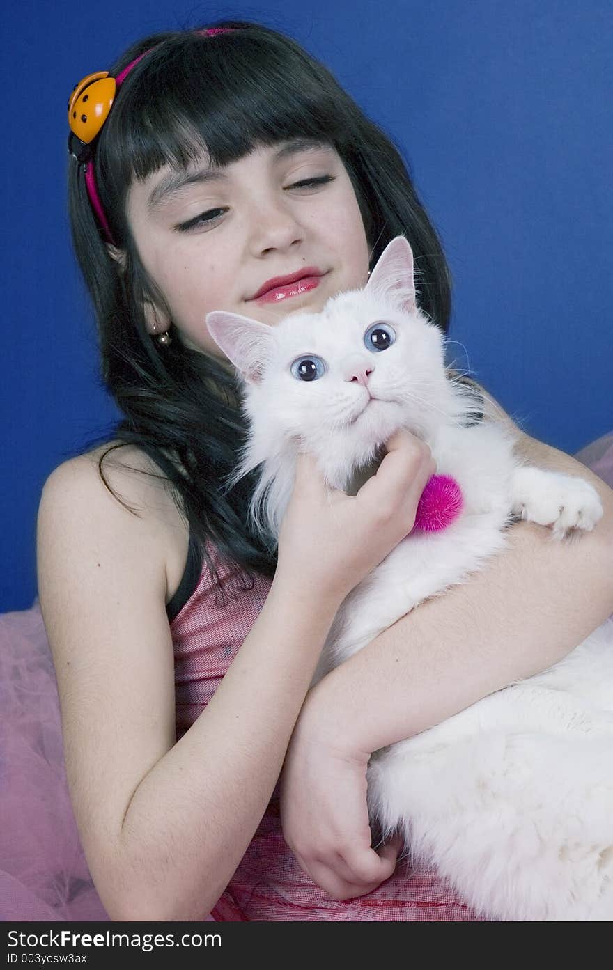 Pretty little girl playing with her cat. Pretty little girl playing with her cat