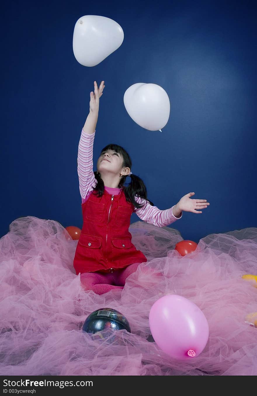 Happy little girl playing with ballons. Happy little girl playing with ballons