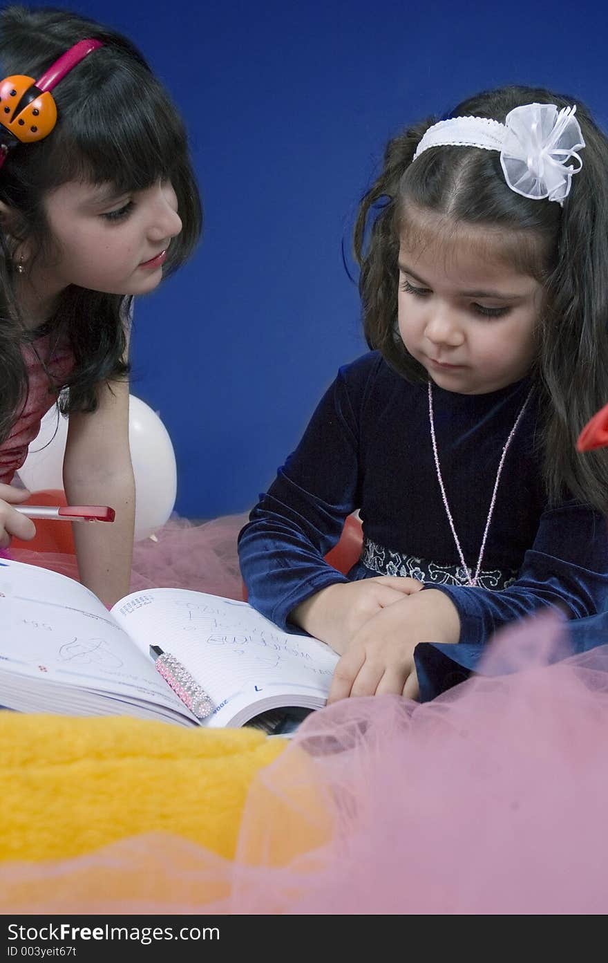 Little girl explaining something to her friend looking focused on the problem, future business women. Little girl explaining something to her friend looking focused on the problem, future business women