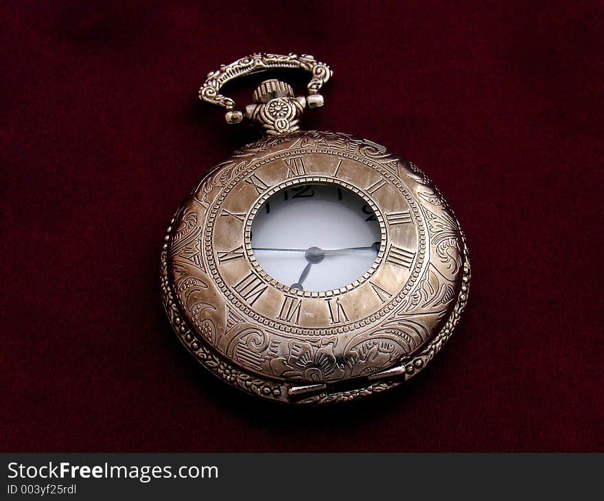 Old silver pocket watch on purple silk background