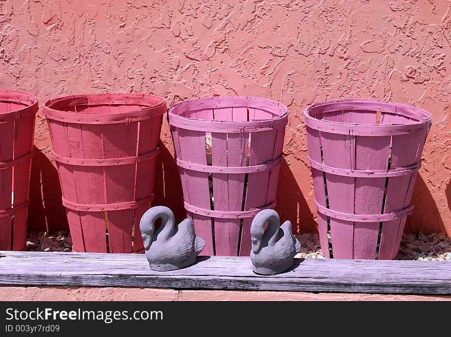 Pastel colored baskets in front of a stucco wall on a sunny day. Pastel colored baskets in front of a stucco wall on a sunny day.