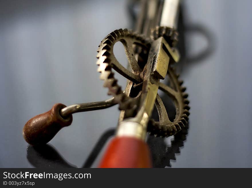 A vintage tool to whisk your eggs. Shallow depth of field centred on the gearwheel. A vintage tool to whisk your eggs. Shallow depth of field centred on the gearwheel.