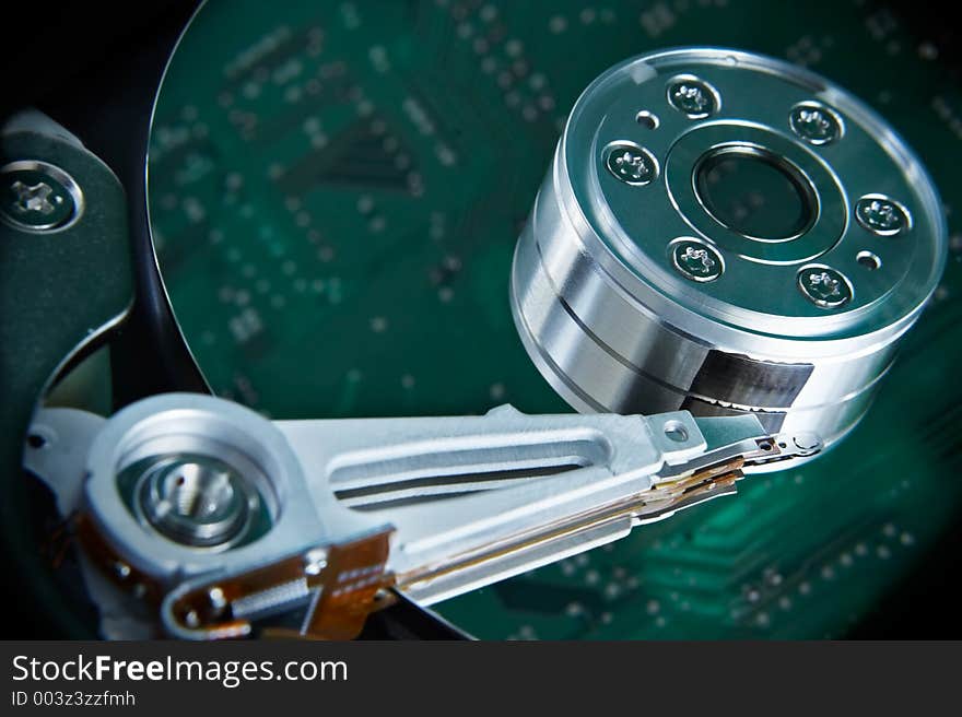 Hard disk with motherboard reflection, standing beside