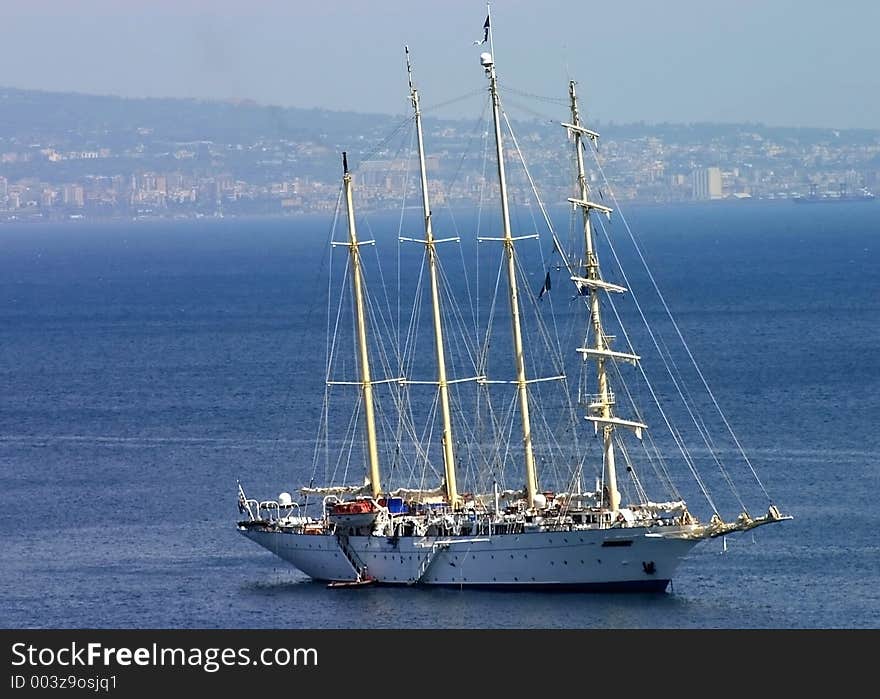 Large sailboat anchored off the Amalfi coast with Naples in the background