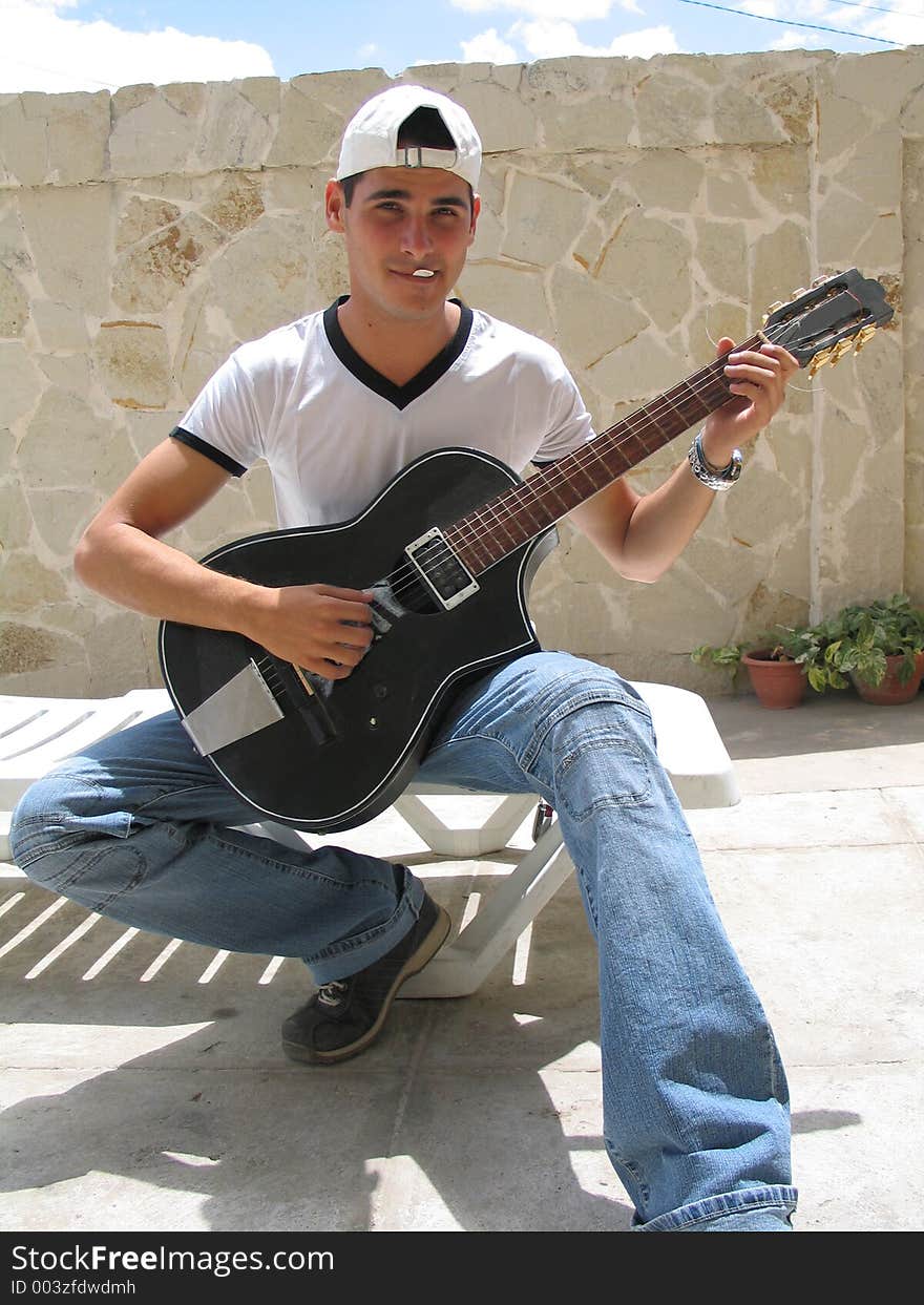 Teenage playing guitar