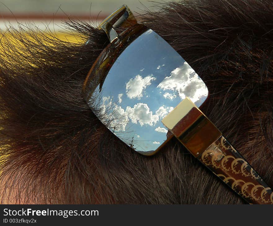 Sky and clouds reflecting in sunglass. Sky and clouds reflecting in sunglass