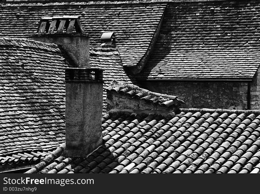 View of old tiled rooftops in the ancient French town of Vezelay. View of old tiled rooftops in the ancient French town of Vezelay.